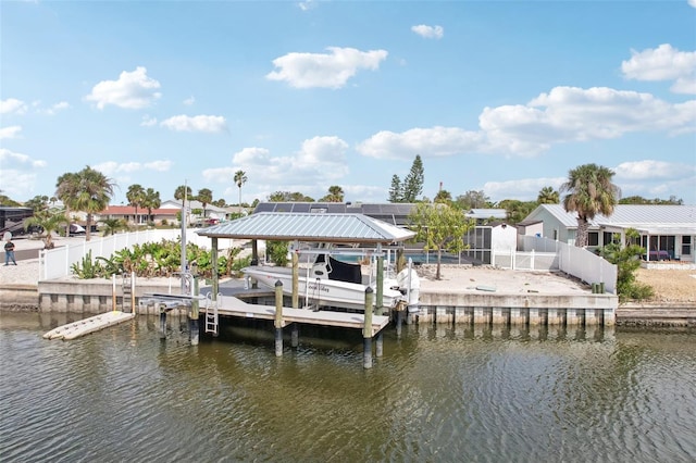 view of dock featuring a water view, boat lift, and fence