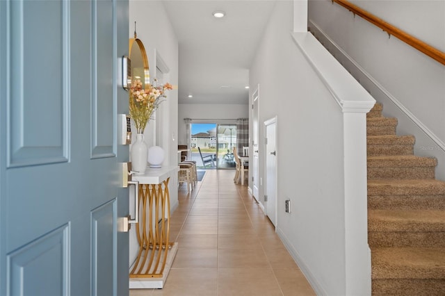 foyer featuring stairs, recessed lighting, baseboards, and light tile patterned floors