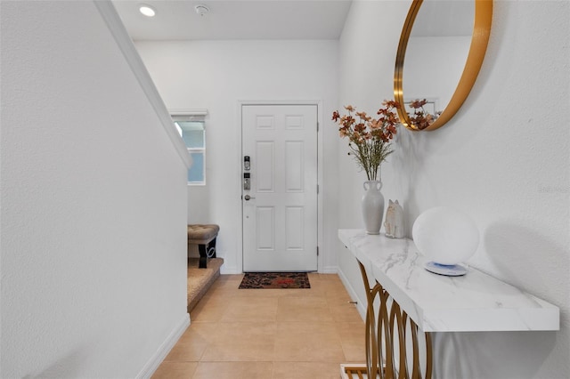 entrance foyer with baseboards and light tile patterned floors