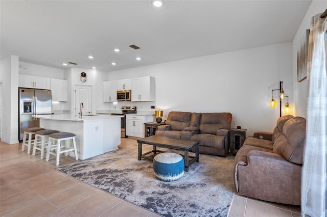 living room with recessed lighting, visible vents, and light tile patterned floors