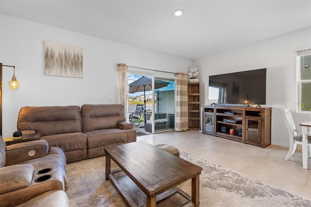 living area featuring light tile patterned floors and recessed lighting