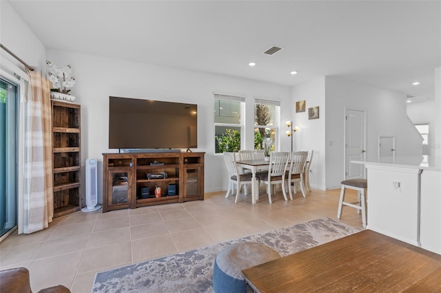 tiled living area with baseboards, visible vents, and recessed lighting