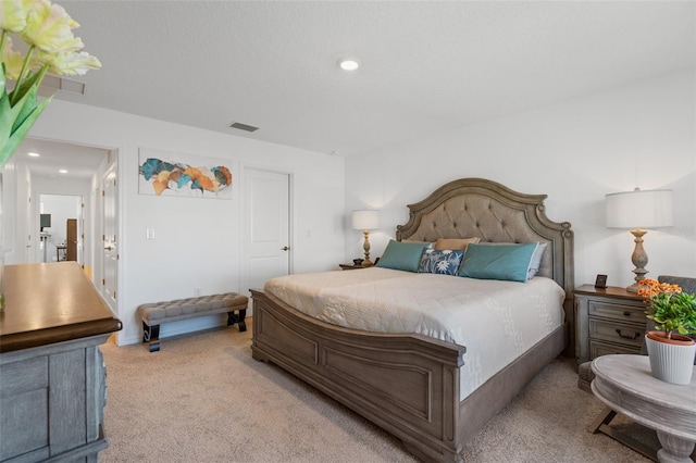 carpeted bedroom with visible vents and recessed lighting