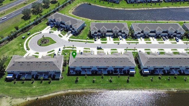 birds eye view of property with a water view and a residential view