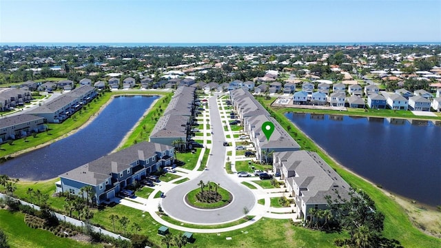 drone / aerial view with a water view and a residential view