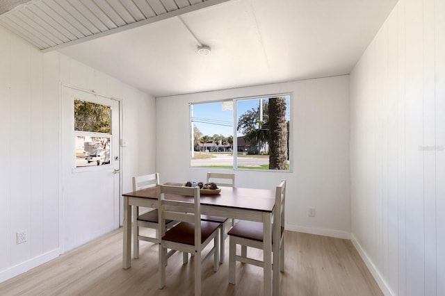 dining room with a healthy amount of sunlight, light wood-type flooring, and baseboards