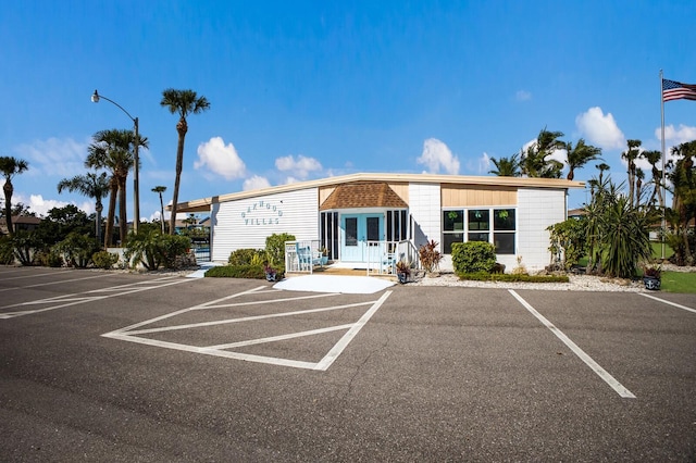 view of building exterior with uncovered parking