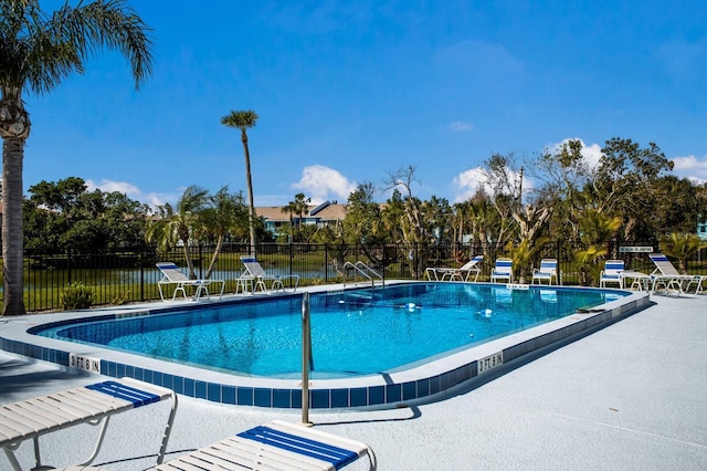 pool featuring a patio area and fence