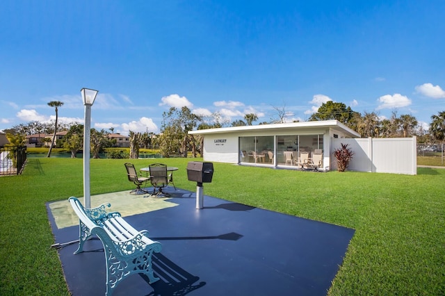 view of patio with a sunroom and fence