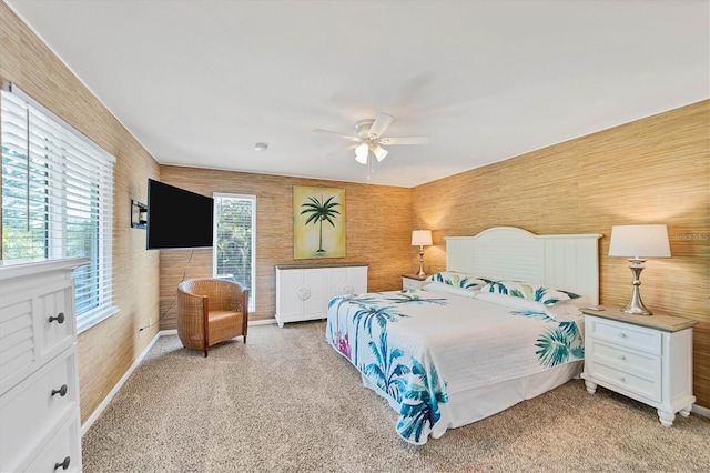 bedroom featuring ceiling fan, baseboards, and light colored carpet