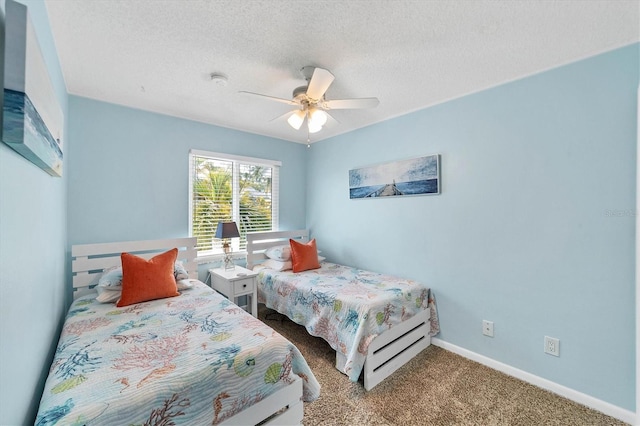 carpeted bedroom featuring a ceiling fan, a textured ceiling, and baseboards