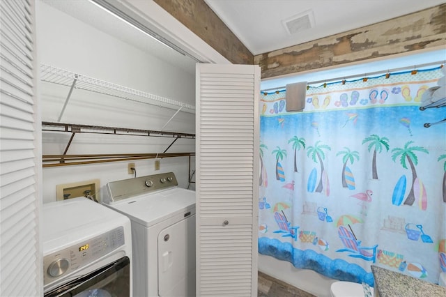 laundry area featuring laundry area, washing machine and clothes dryer, and visible vents