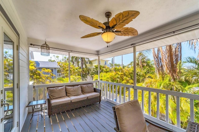 sunroom / solarium with a ceiling fan