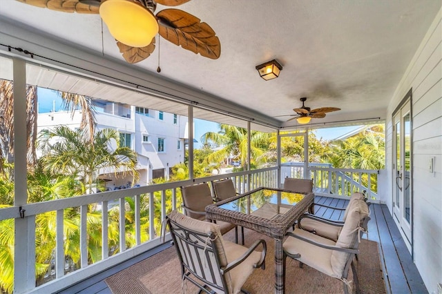 sunroom with a wealth of natural light and a ceiling fan