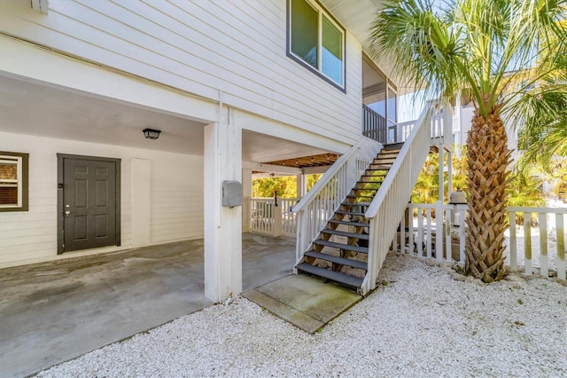 exterior space featuring a carport and stairway