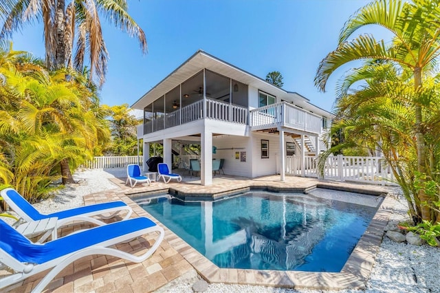 back of house with a sunroom, a fenced backyard, ceiling fan, stairs, and a patio area