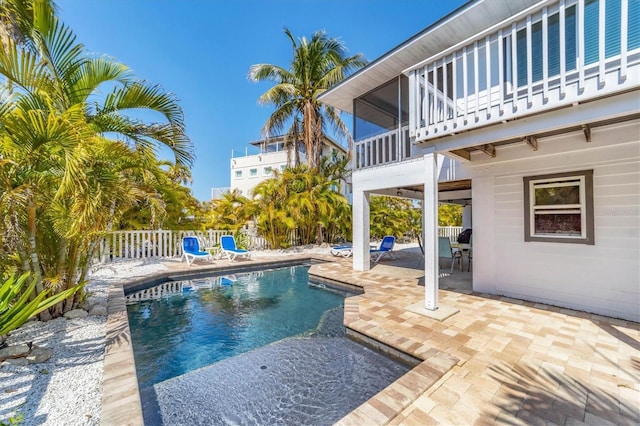 view of swimming pool featuring a fenced in pool, a patio area, and fence