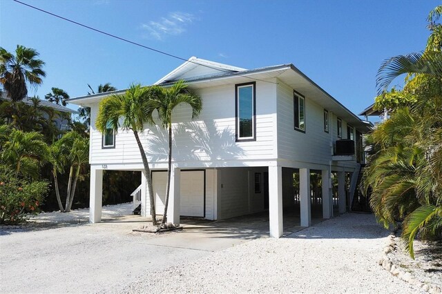 exterior space featuring a carport and gravel driveway