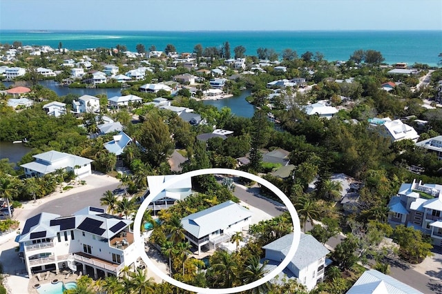 birds eye view of property with a water view and a residential view