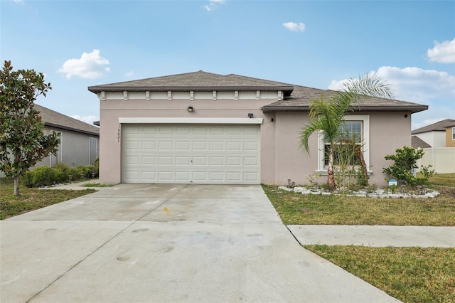 view of front of home featuring a garage, concrete driveway, and stucco siding