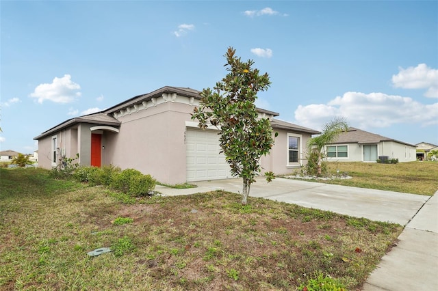 view of front of home with a garage, a front yard, concrete driveway, and stucco siding