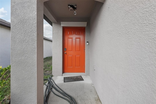 doorway to property with stucco siding