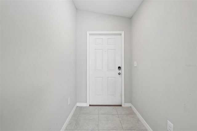 entryway featuring baseboards and light tile patterned flooring