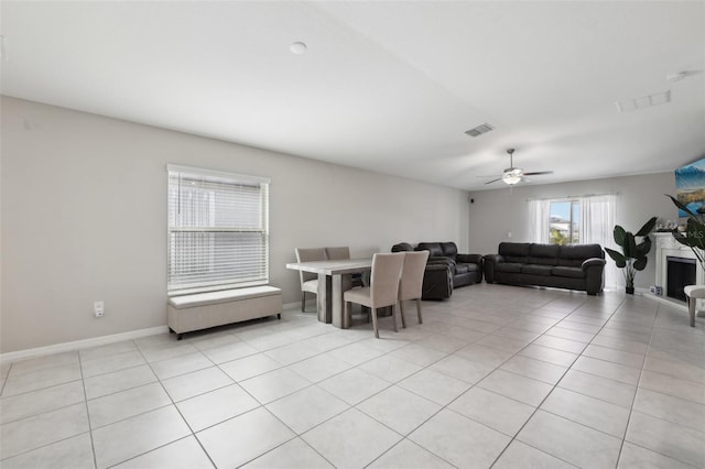 dining space with a ceiling fan, visible vents, baseboards, and light tile patterned floors