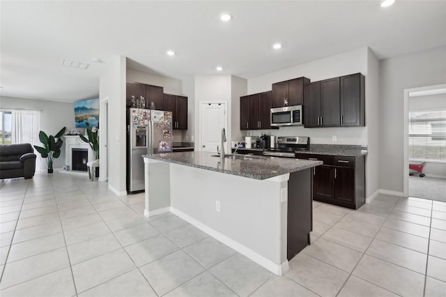 kitchen featuring a healthy amount of sunlight, stainless steel appliances, a sink, and open floor plan