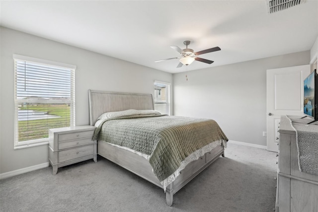 bedroom featuring carpet floors, visible vents, ceiling fan, and baseboards