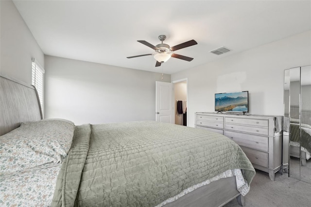 bedroom with light colored carpet, ceiling fan, and visible vents