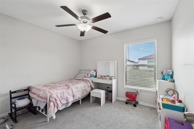 carpeted bedroom with a ceiling fan and baseboards