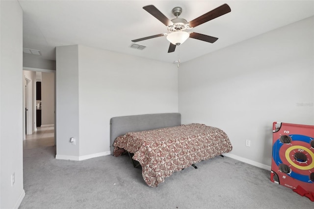 carpeted bedroom featuring visible vents, ceiling fan, and baseboards