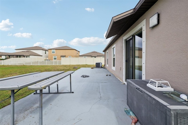 view of patio with a residential view, a fenced backyard, and central air condition unit