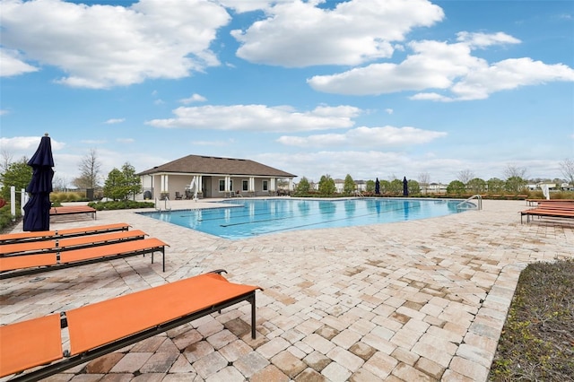 pool featuring a patio and fence