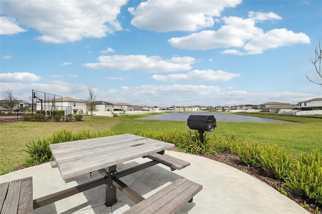 surrounding community with a residential view, outdoor dining area, a lawn, and a patio