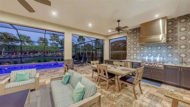 exterior space featuring a ceiling fan, an outdoor kitchen, outdoor dining area, grilling area, and an outdoor hangout area