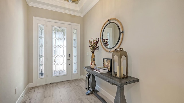 entrance foyer with light wood finished floors, crown molding, and baseboards