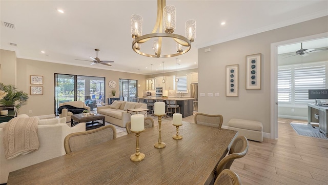 dining room with recessed lighting, visible vents, crown molding, and light wood finished floors