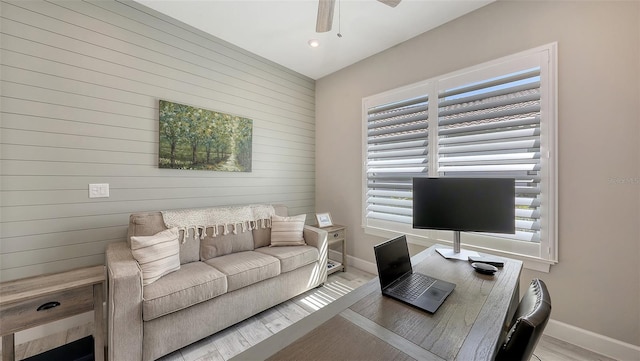 office featuring a ceiling fan, baseboards, and wood finished floors