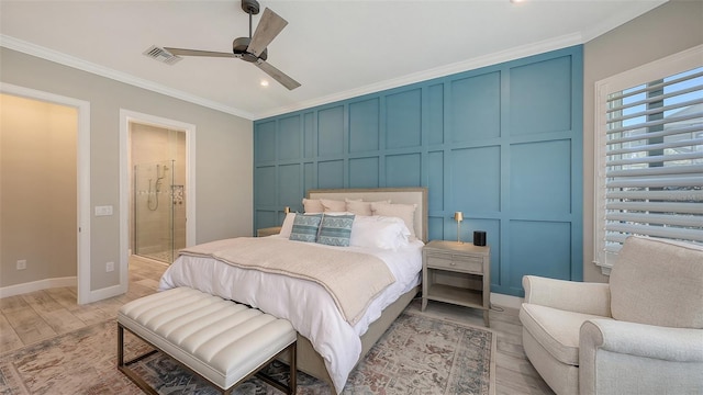 bedroom featuring visible vents, ornamental molding, connected bathroom, light wood-style floors, and a decorative wall