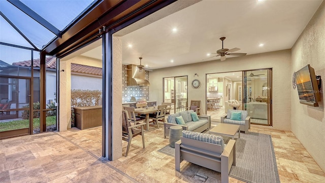 view of patio / terrace featuring an outdoor living space, a ceiling fan, and a lanai