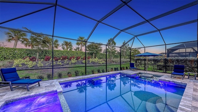 outdoor pool with a lanai and a patio area