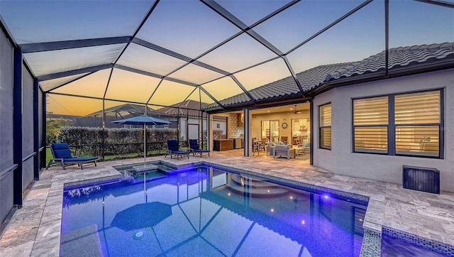 view of swimming pool featuring glass enclosure, a patio area, a fenced in pool, and an outdoor hangout area