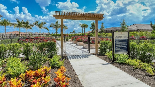 view of property's community with a gate and fence