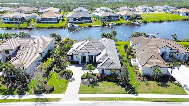 drone / aerial view with a residential view and a water view