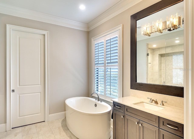 full bathroom featuring vanity, baseboards, a freestanding bath, a stall shower, and crown molding