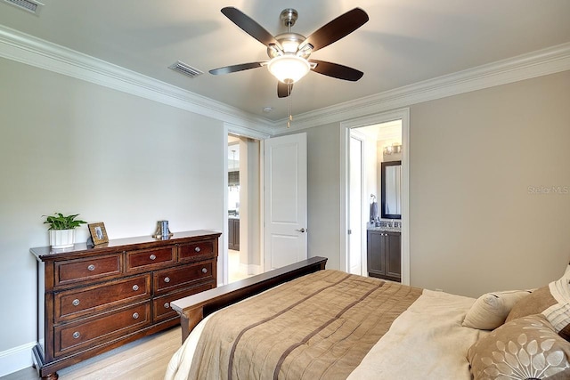 bedroom featuring crown molding, light wood finished floors, visible vents, connected bathroom, and ceiling fan