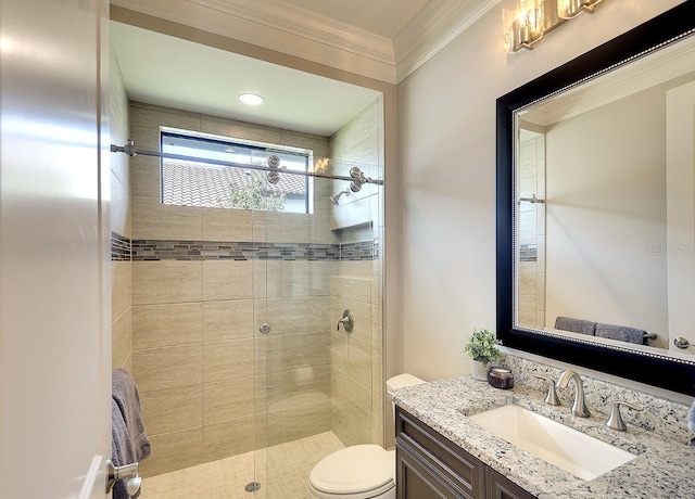 full bathroom featuring a stall shower, crown molding, vanity, and toilet