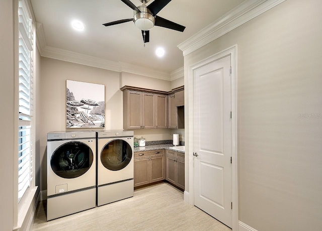 washroom with a ceiling fan, independent washer and dryer, cabinet space, and crown molding